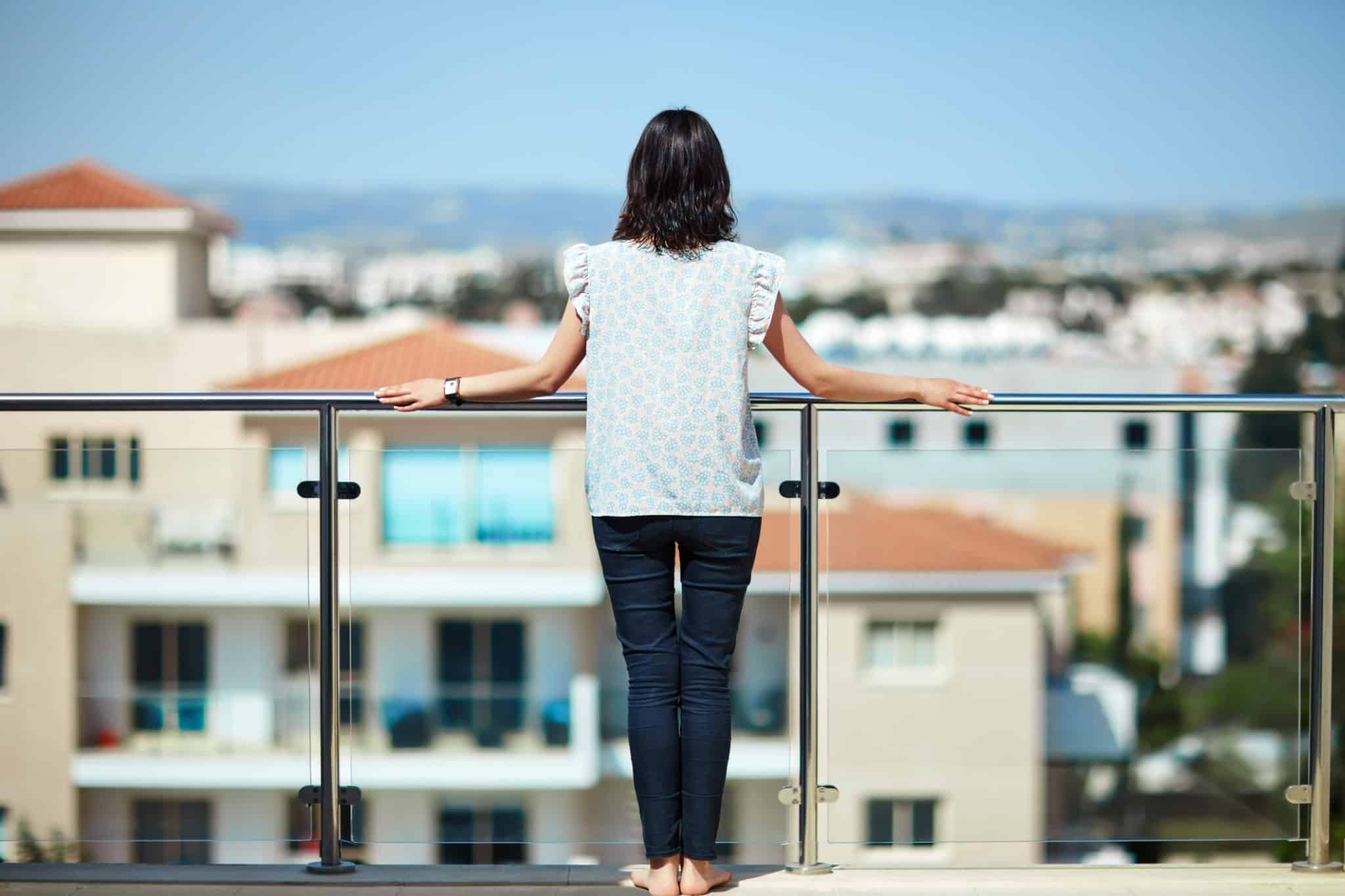 Woman enjoying cityscape standing on rooftop
